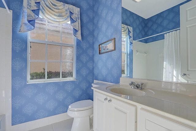 bathroom featuring toilet, vanity, a shower with shower curtain, and tile patterned flooring