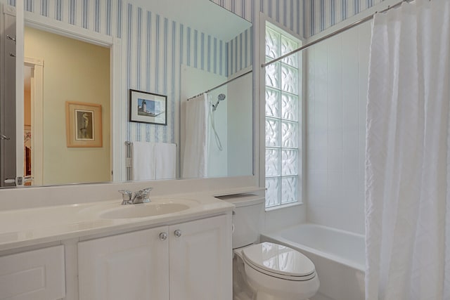 full bathroom with vanity, shower / tub combo, and toilet