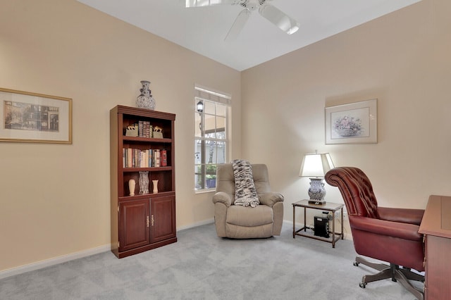 carpeted home office featuring ceiling fan