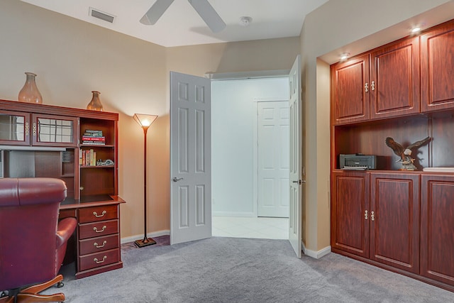 carpeted office space with ceiling fan