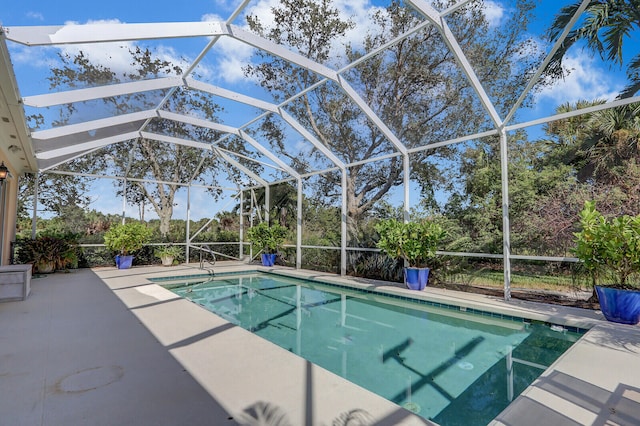 view of swimming pool featuring a patio and a lanai