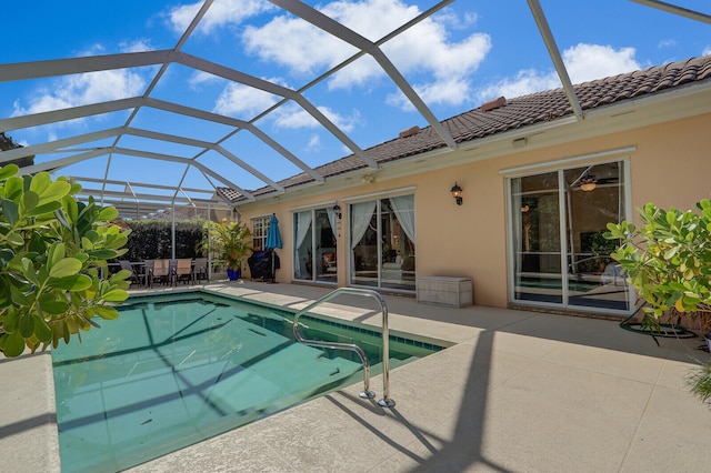 view of swimming pool featuring a patio and a lanai