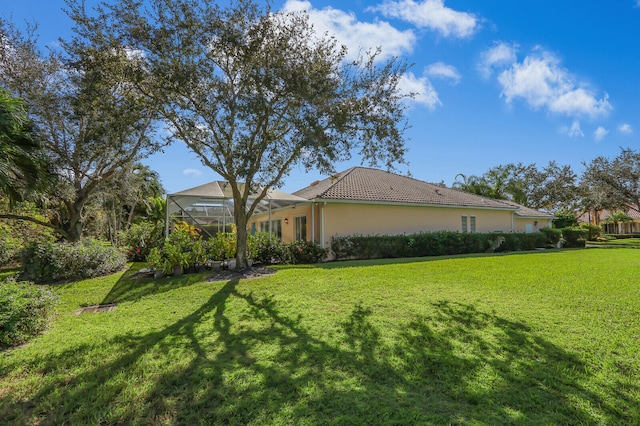 view of property exterior with a lanai and a lawn