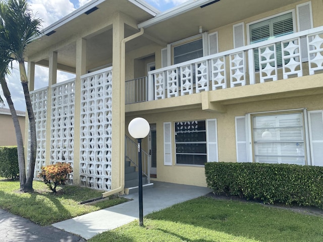 view of exterior entry featuring a balcony