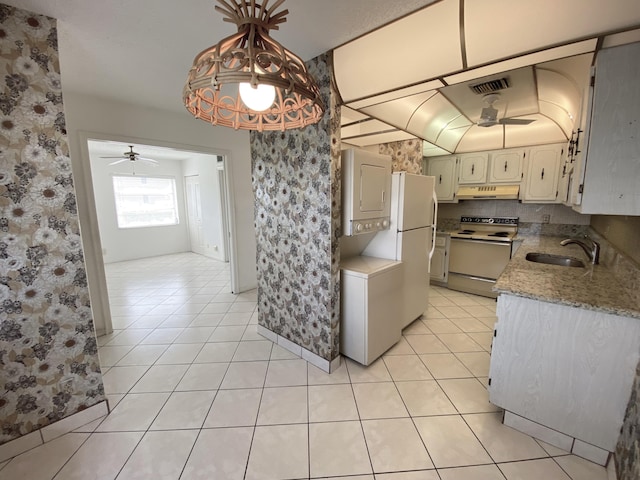 kitchen with pendant lighting, white appliances, light tile patterned floors, and sink