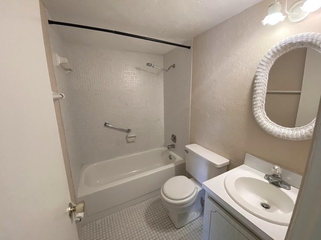 full bathroom featuring tile patterned floors, vanity, toilet, and tiled shower / bath combo