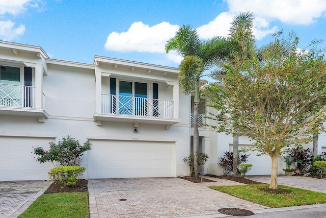 multi unit property with a balcony and a garage