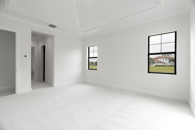 carpeted empty room featuring ornamental molding and wooden ceiling