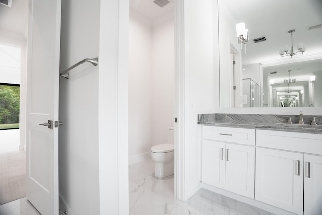 bathroom with vanity, toilet, ornamental molding, and walk in shower