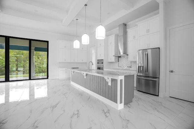 kitchen with tasteful backsplash, white cabinetry, beamed ceiling, wall chimney exhaust hood, and stainless steel appliances