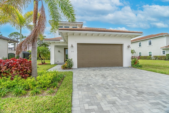 mediterranean / spanish-style home featuring a front yard and a garage