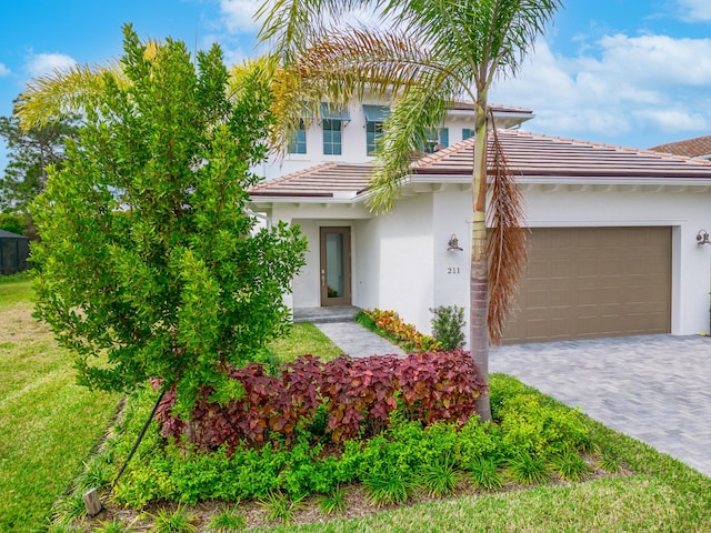 view of front of home featuring a front yard and a garage