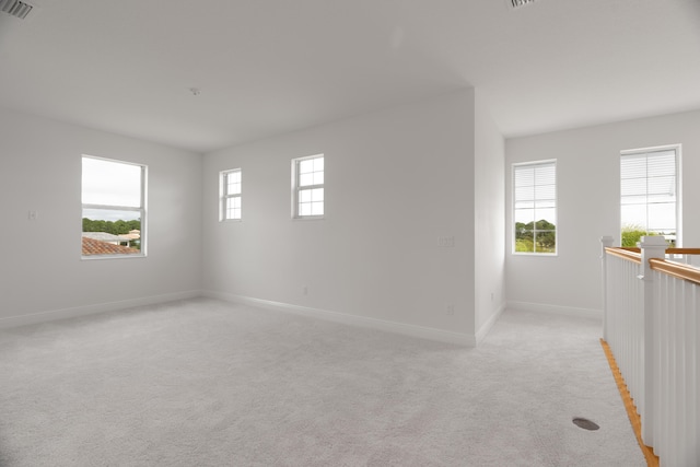 spare room featuring light colored carpet