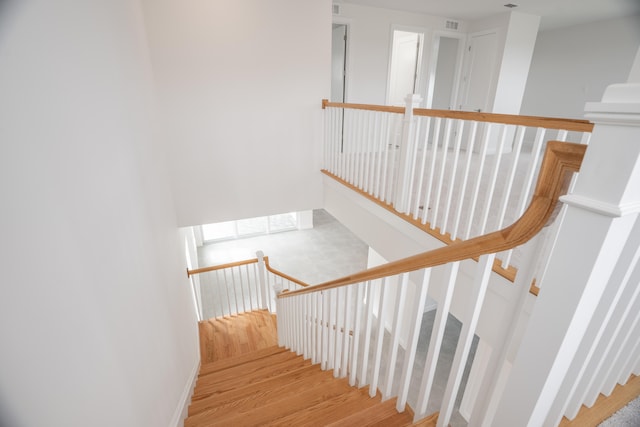 stairs featuring hardwood / wood-style floors