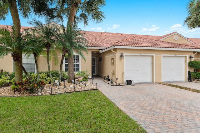 view of front of home with a front lawn and a garage