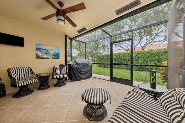 sunroom / solarium featuring ceiling fan