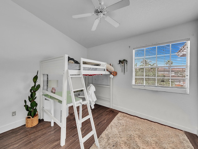 bedroom with dark hardwood / wood-style flooring and ceiling fan