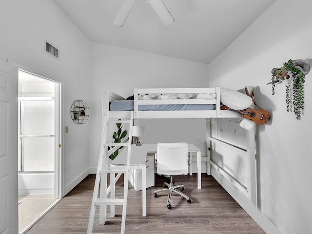 bedroom featuring lofted ceiling, dark wood-type flooring, and ceiling fan