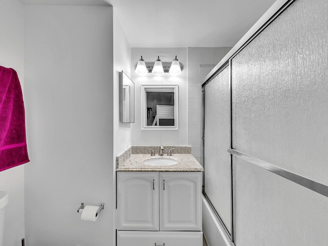 bathroom with vanity and enclosed tub / shower combo