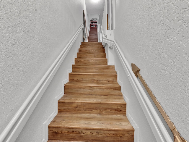 stairway with hardwood / wood-style flooring