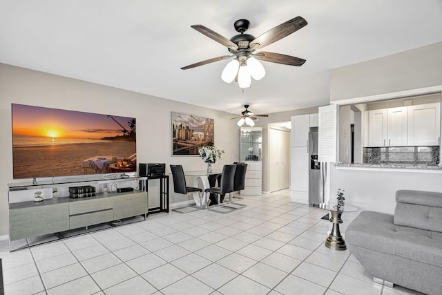 tiled living room with ceiling fan