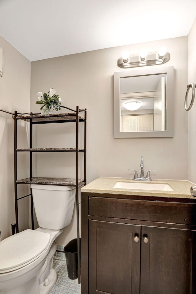 bathroom featuring vanity, toilet, and tile patterned floors