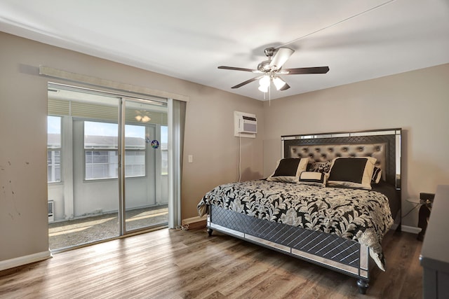 bedroom with hardwood / wood-style floors, a wall unit AC, access to exterior, and ceiling fan