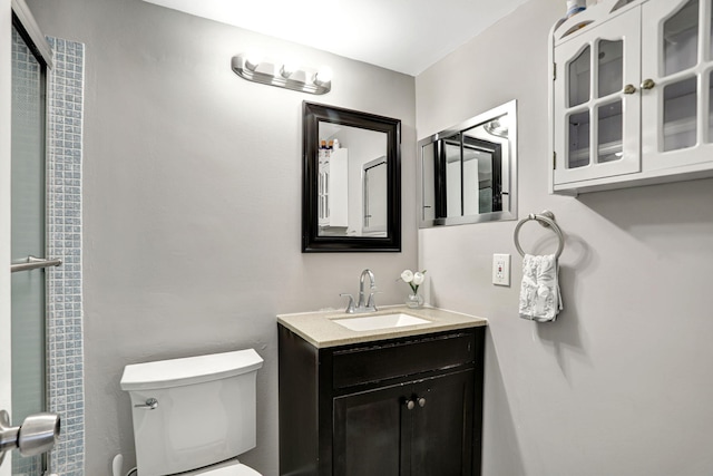 bathroom featuring toilet and vanity