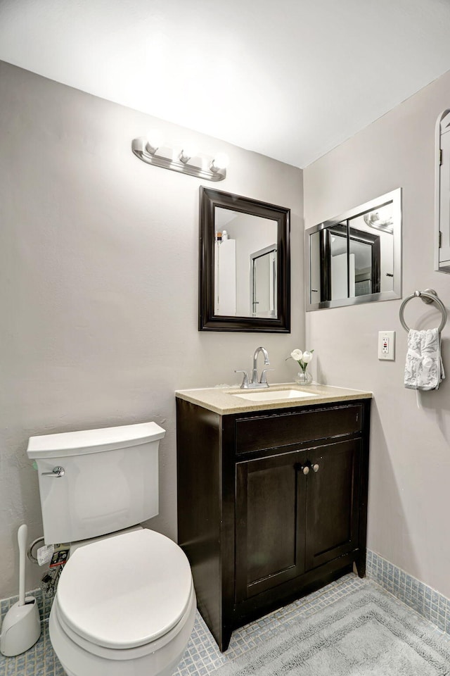 bathroom with vanity, toilet, and tile patterned floors