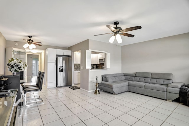 living room with ceiling fan and light tile patterned floors