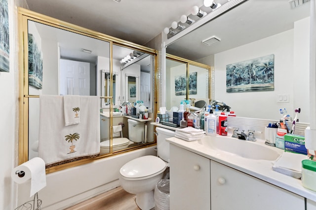 full bathroom with shower / bath combination with glass door, vanity, wood-type flooring, and toilet