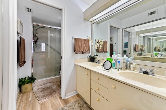 bathroom with vanity, hardwood / wood-style floors, walk in shower, and toilet