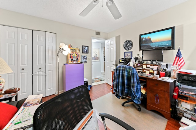 office space featuring ceiling fan, a textured ceiling, and hardwood / wood-style floors