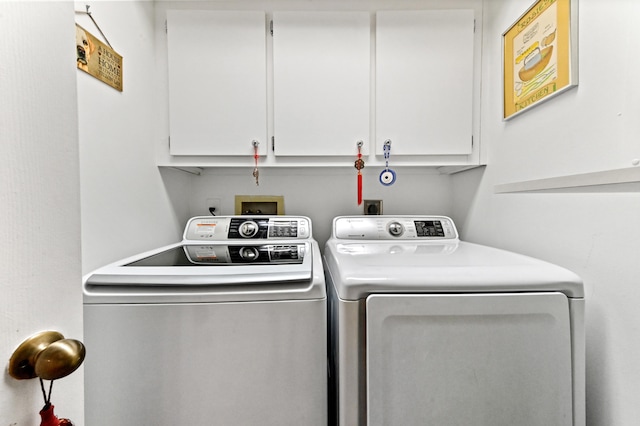 laundry room featuring cabinets and washing machine and clothes dryer