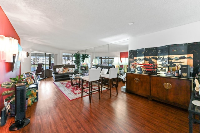 dining space featuring a textured ceiling and wood-type flooring