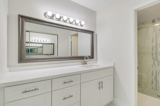 bathroom with a shower with door, tile patterned floors, and vanity