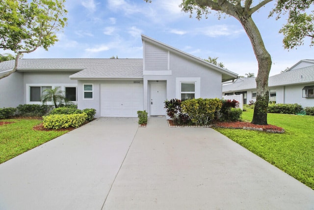 view of front facade with a garage and a front lawn