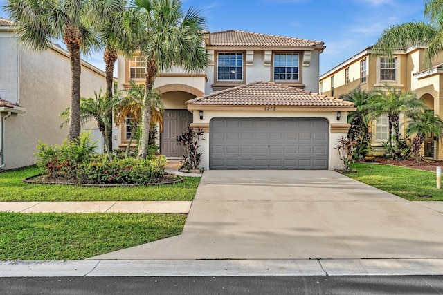 mediterranean / spanish home with a front yard