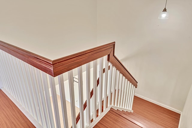 stairway with hardwood / wood-style floors