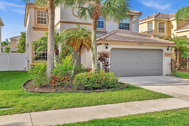 mediterranean / spanish-style home featuring a front yard and a garage