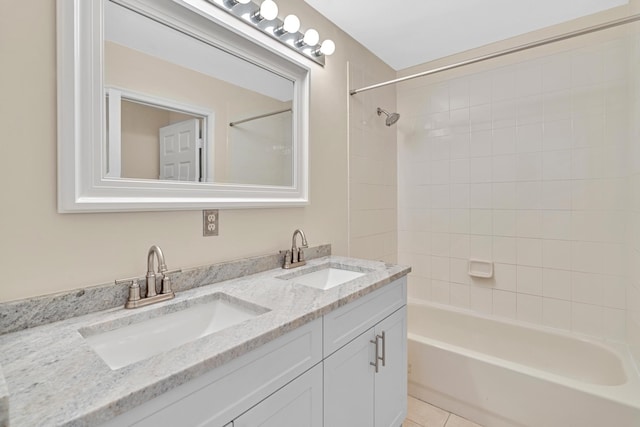 bathroom featuring vanity, tiled shower / bath combo, and tile patterned flooring