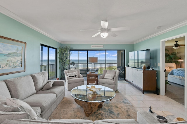 living room featuring crown molding, light tile patterned floors, and ceiling fan