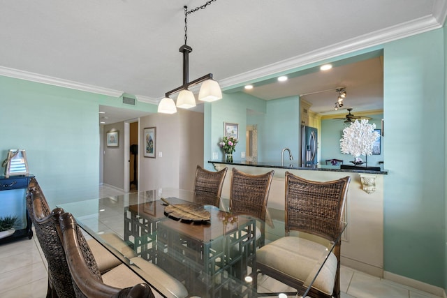 2571 NE Ocean Blvd Unit 10-203, Stuart, FL 34996 - dining room featuring light tile patterned flooring, ornamental molding, and baseboards