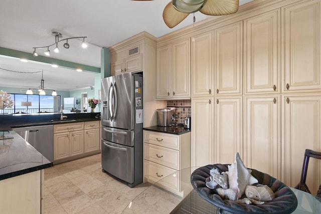 2571 NE Ocean Blvd Unit 10-203, Stuart, FL 34996 - kitchen with cream cabinetry, stainless steel appliances, a sink, ceiling fan, and decorative backsplash
