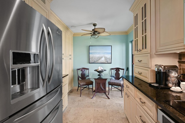 2571 NE Ocean Blvd Unit 10-203, Stuart, FL 34996 - kitchen featuring stainless steel refrigerator with ice dispenser, cream cabinetry, a ceiling fan, glass insert cabinets, and ornamental molding