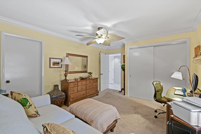 carpeted bedroom featuring ornamental molding, a closet, and ceiling fan