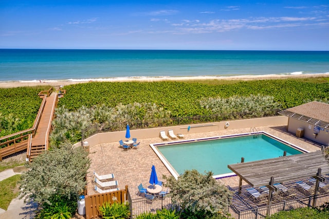 exterior space featuring a water view, a view of the beach, and a patio