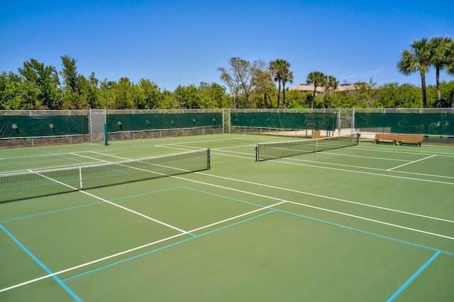 2571 NE Ocean Blvd Unit 10-203, Stuart, FL 34996 - view of tennis court featuring community basketball court and fence