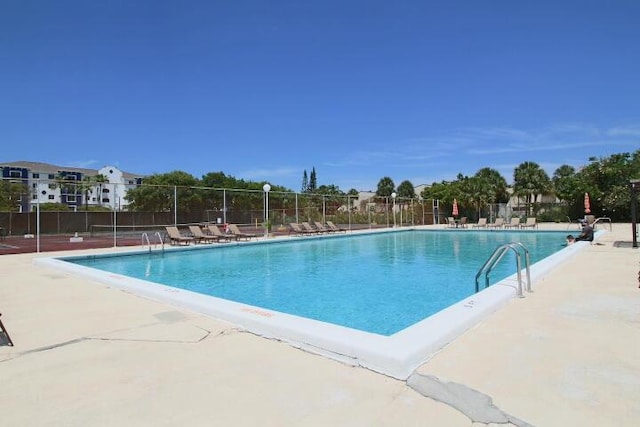 pool featuring a patio and fence