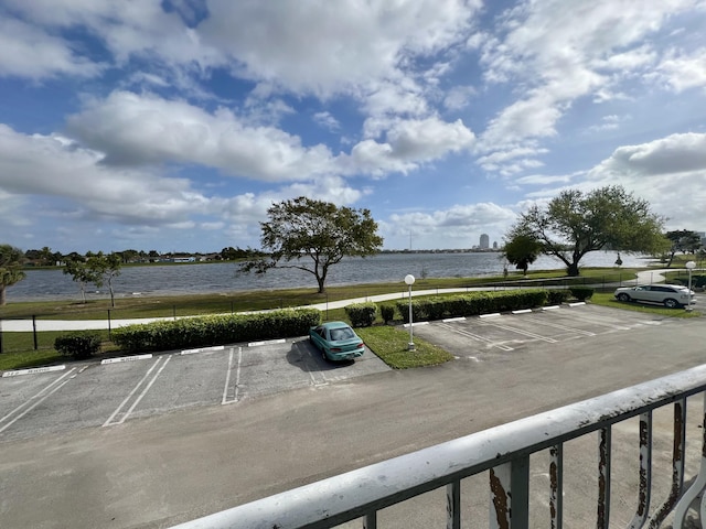 uncovered parking lot with a water view